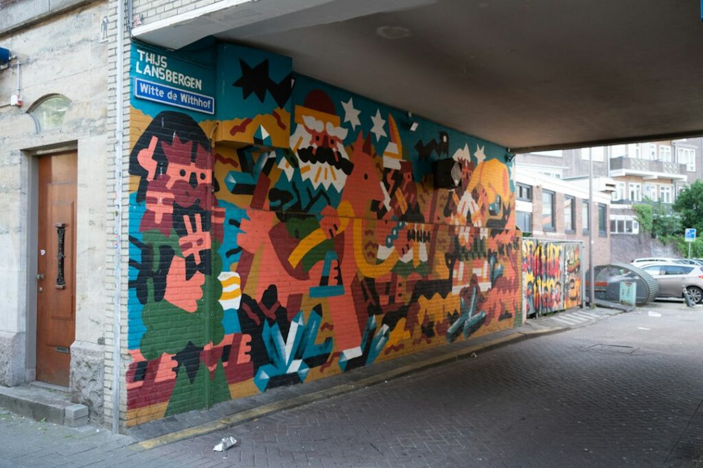 Vibrant painted mural covering the walls of an urban underpass, an example of public art commissioned for a shared space