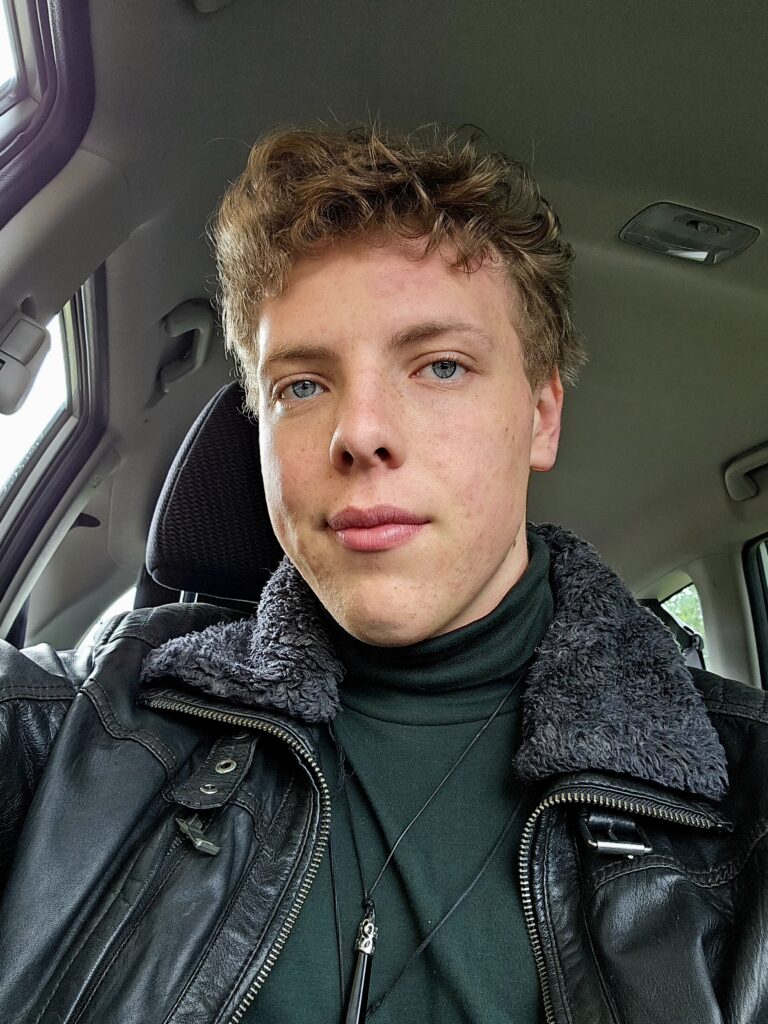 James Carter in a leather jacket in a car