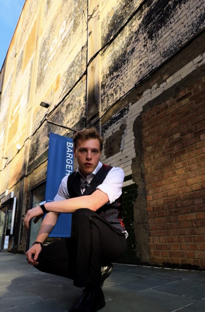 Portrait of James Carter crouching at Bargehouse, London