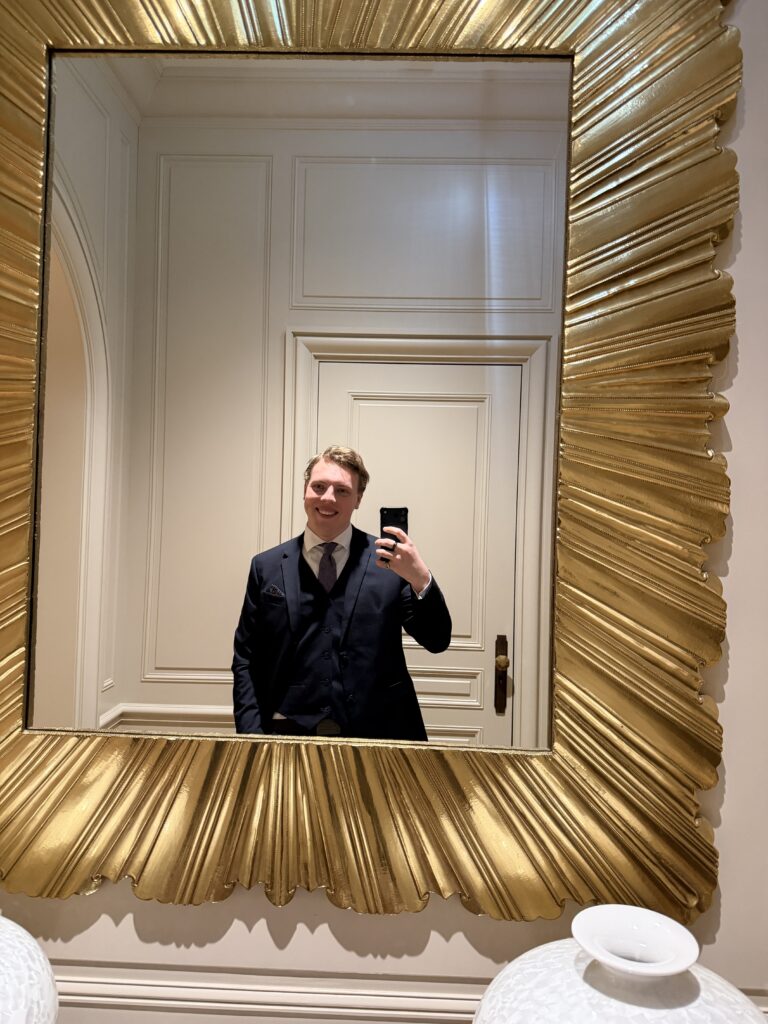 James Carter in a gold mirror at a hotel in Geneva