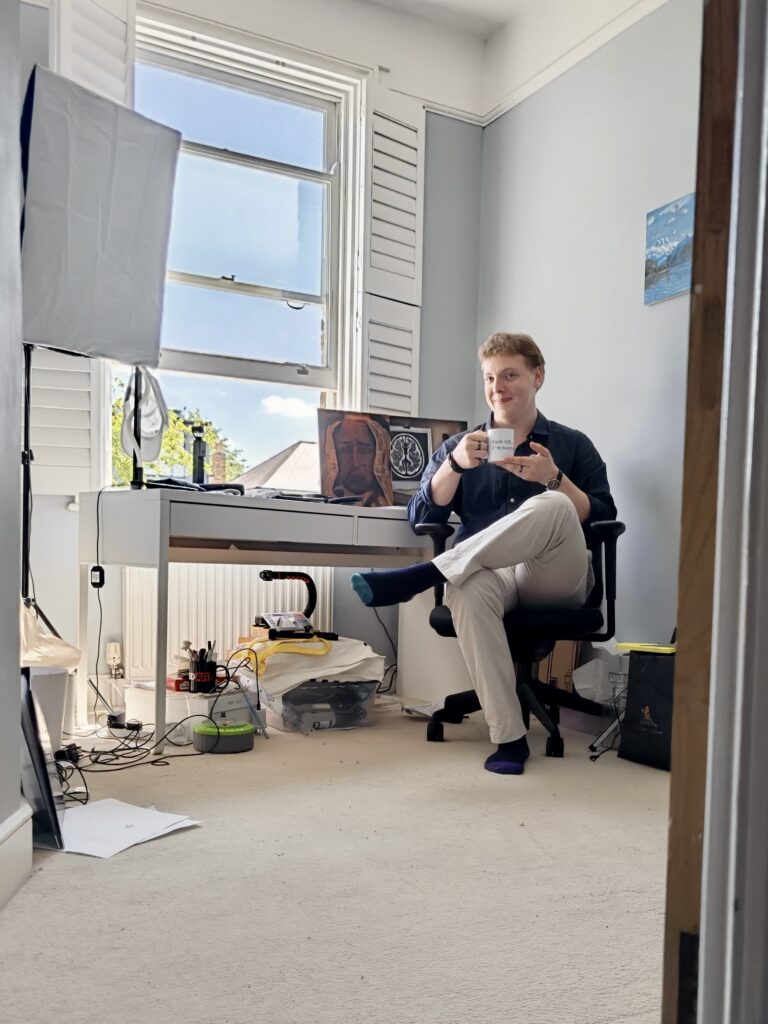 James Carter at his home studio desk by a window