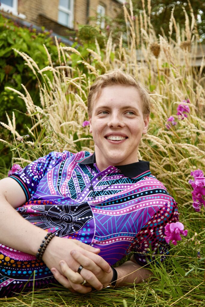 James Carter lying in a wildflower meadow