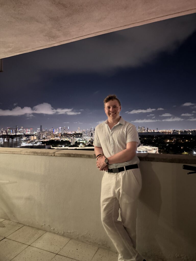 James Carter on a balcony overlooking the Miami skyline at night