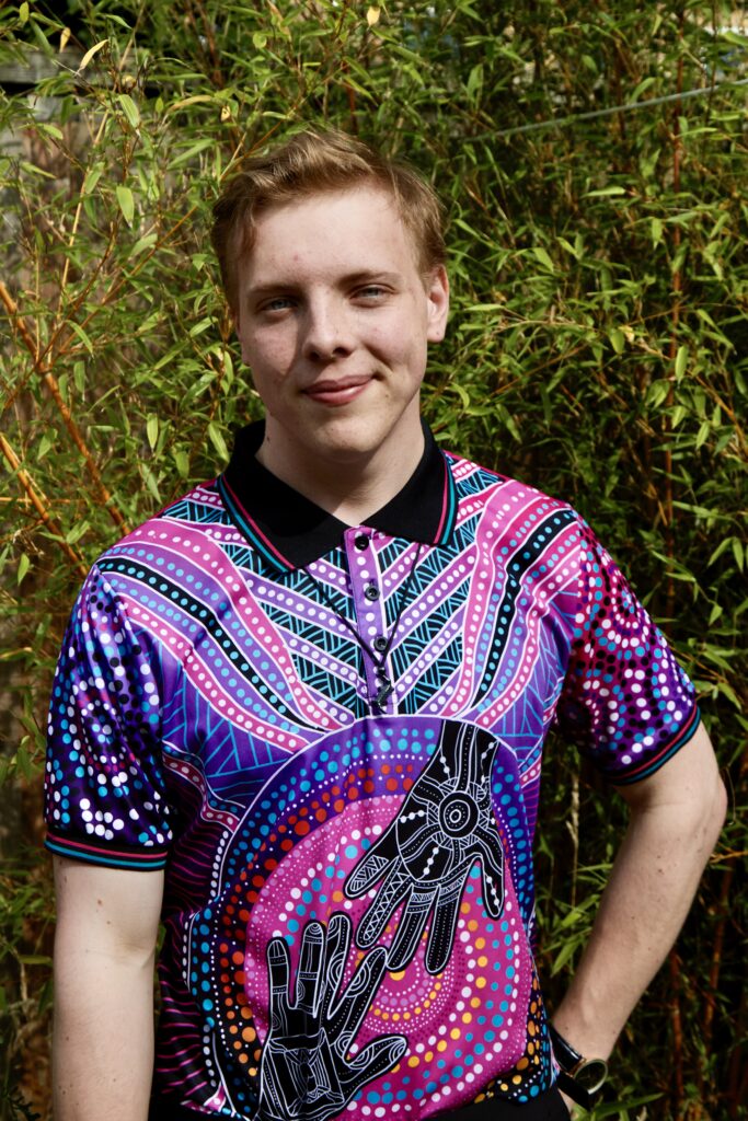 Portrait of James Carter in a patterned shirt among bamboo