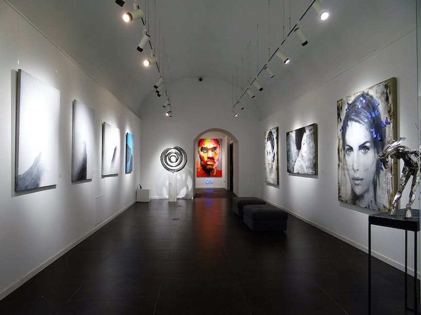 Image of an art exhibition with diverse artworks displayed in a museum setting