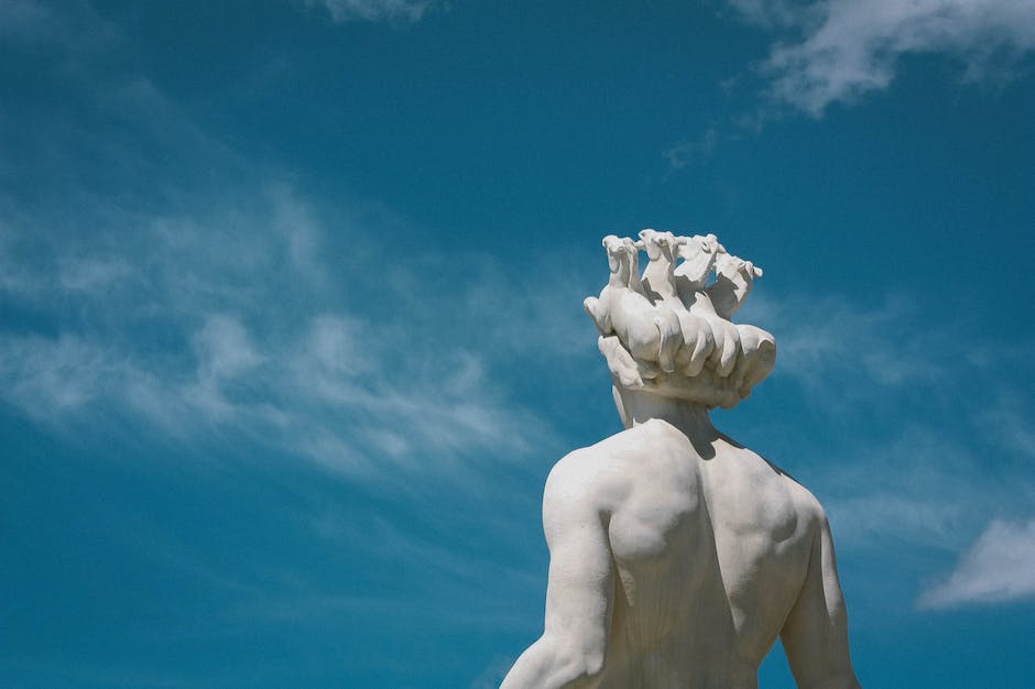 An image of a Greek sculpture depicting a standing male figure